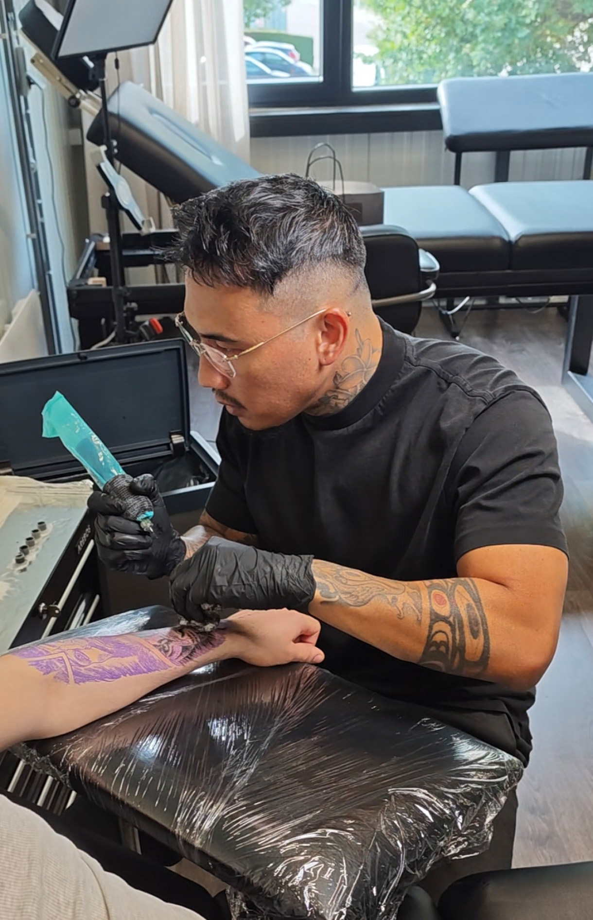 J. West in the tattoo studio